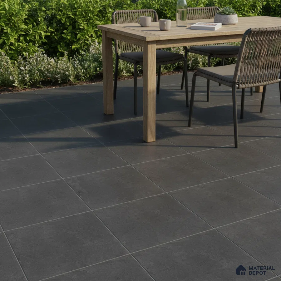 Minimalist outdoor space with charcoal grey stone-look floor tiles and natural wood dining set