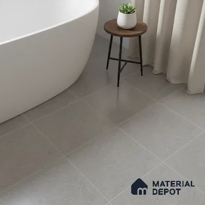 Minimalist bathroom with matte grey stone-look floor tiles and freestanding tub