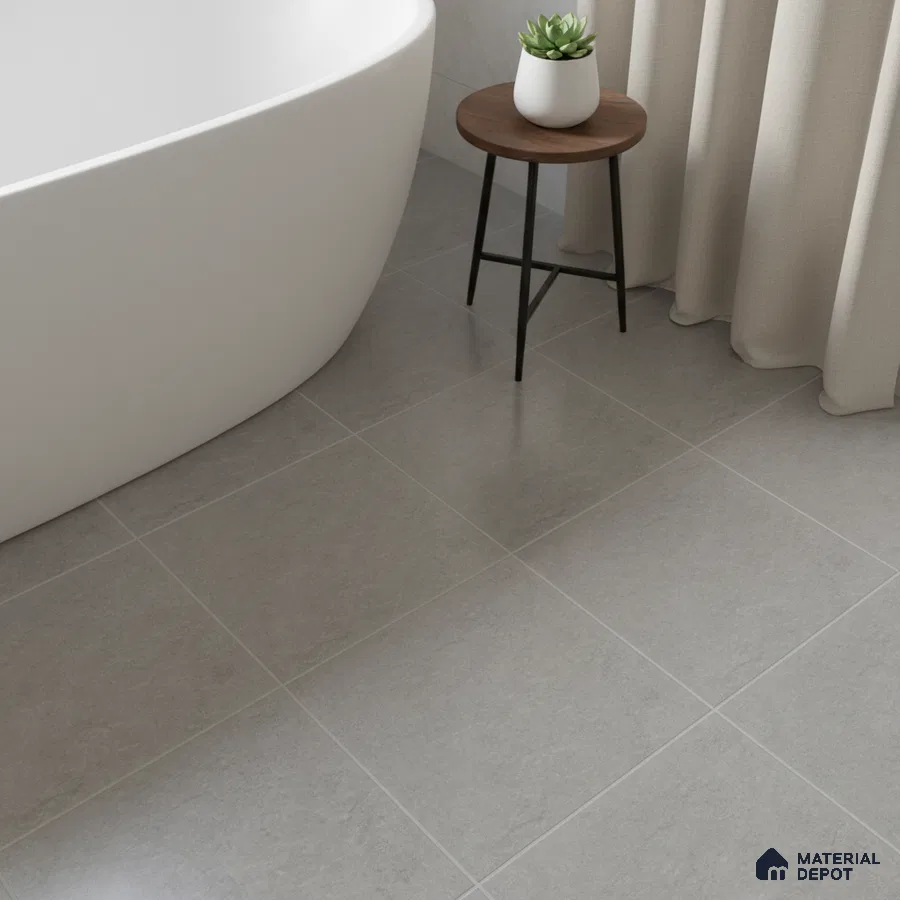 Minimalist bathroom with matte grey stone-look floor tiles and freestanding tub