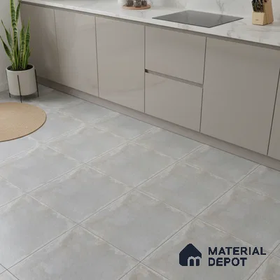 Modern kitchen with beige matte laminate cabinets, white marble-look countertop, and light grey stone floor tiles