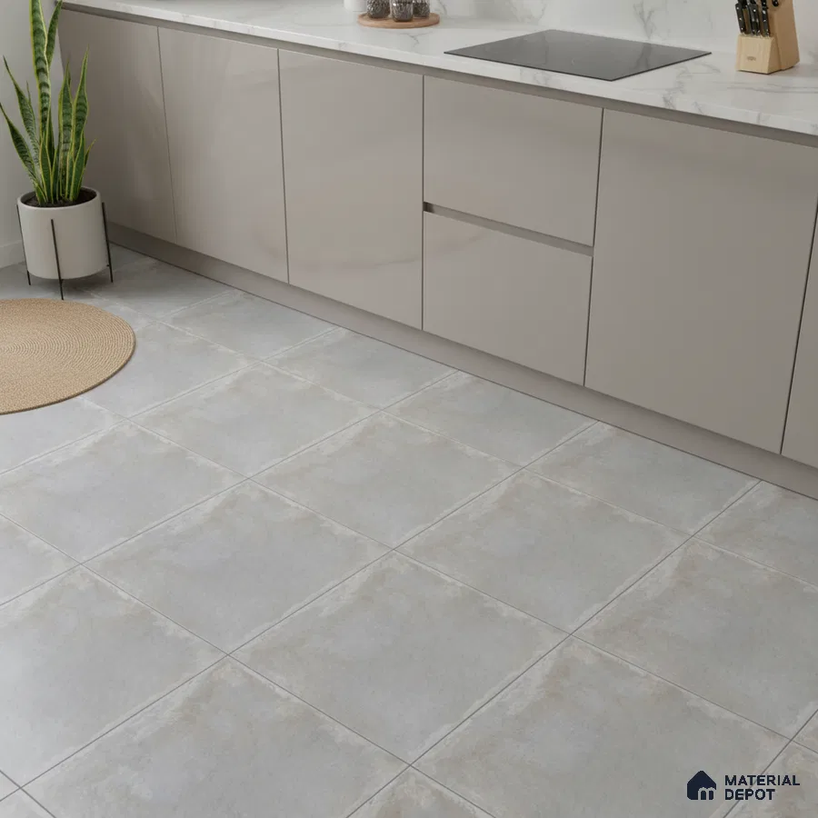 Modern kitchen with beige matte laminate cabinets, white marble-look countertop, and light grey stone floor tiles