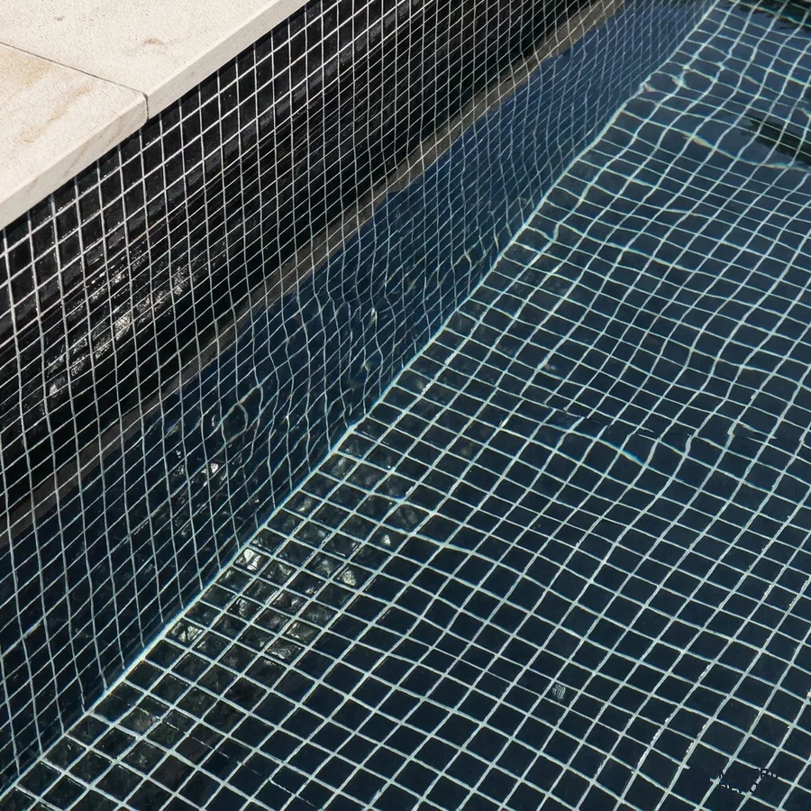 Modern Swimming Pool with Dark Charcoal Glass Mosaic Tile and Stone Coping