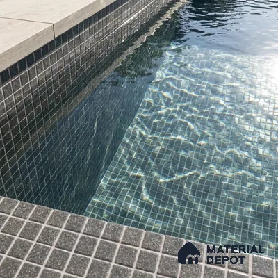 Modern Swimming Pool with Charcoal Grey Glass Mosaic Tile and Stone Coping