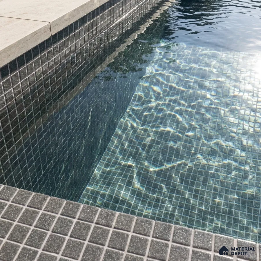 Modern Swimming Pool with Charcoal Grey Glass Mosaic Tile and Stone Coping