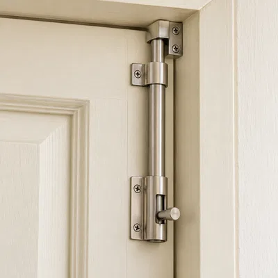 Tower Bolts - stainless steel tower bolt fixed vertically on a cream painted door