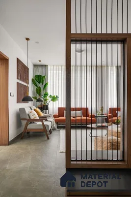 Tranquil Living Space with Vertical Bar Partition and Warm Accents | Material Depot