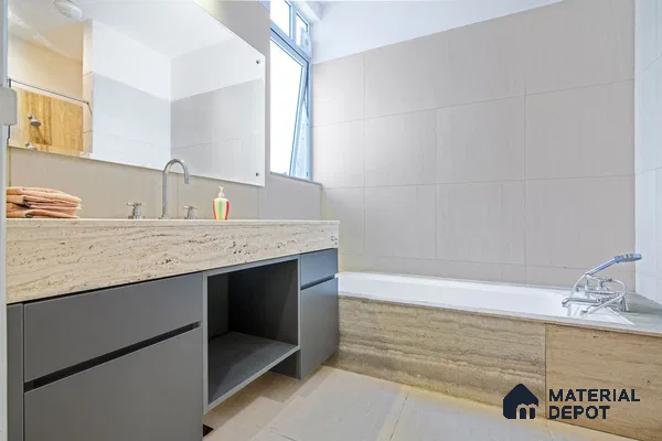 Contemporary bathroom with textured wall tiles.