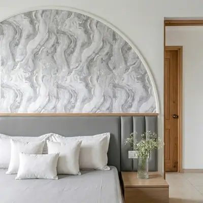 Minimalist bedroom with grey marble-look wallpaper accent and upholstered headboard