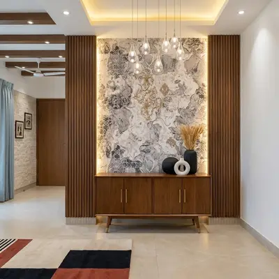 Modern foyer with walnut wood louvers, patterned marble accent wall, and beige floor tiles