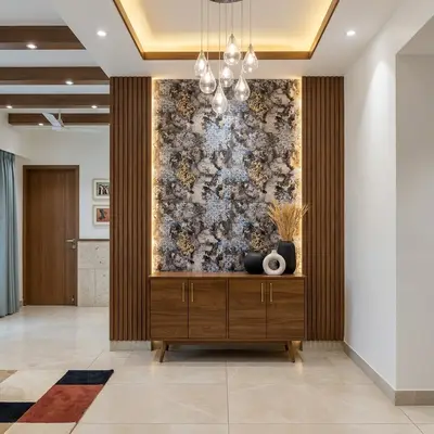 Modern foyer with walnut wood laminate, marble-look luxury backlit panel, and beige floor tiles