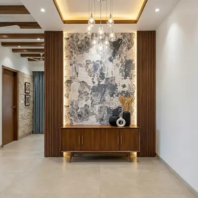 Modern foyer with walnut wood laminate console, marble accent wall, and vertical wooden louvers