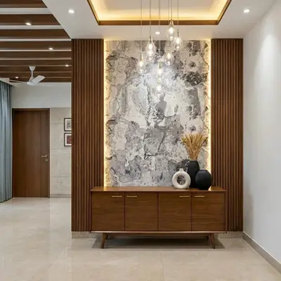 Modern foyer with walnut wood laminate, marble accent wall, and backlit panels
