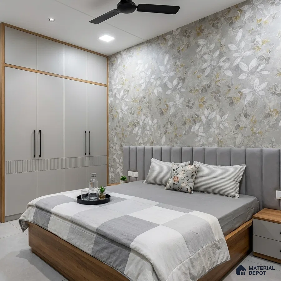 Modern bedroom with floral wallpaper, grey upholstered headboard, and light grey wardrobe with wood accents