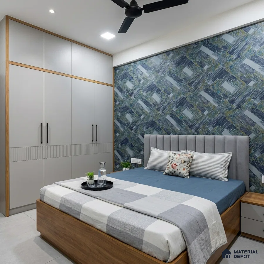 Modern bedroom with grey solid laminate wardrobe, blue geometric wallpaper, and wood finish bed