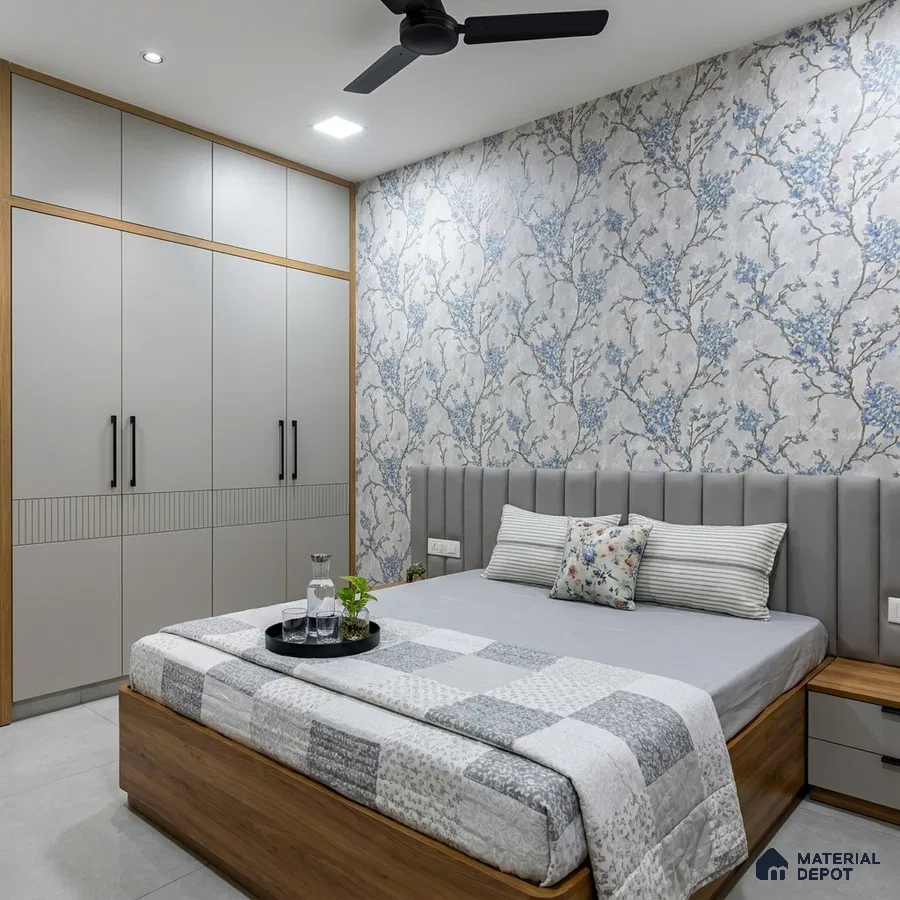 Modern bedroom with blue floral wallpaper, grey upholstered headboard, and light grey wardrobe laminate