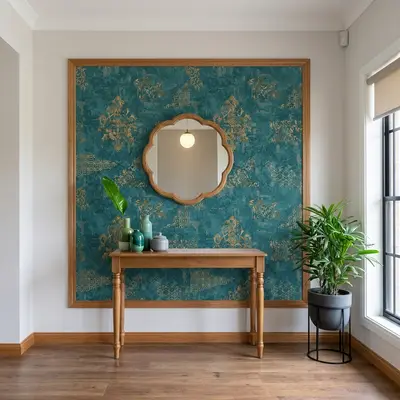 Eclectic foyer with teal and gold patterned wallpaper, natural wood console, and wooden flooring