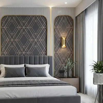 Art Deco bedroom with geometric wallpaper, fluted wall panels, and grey suede upholstered bed