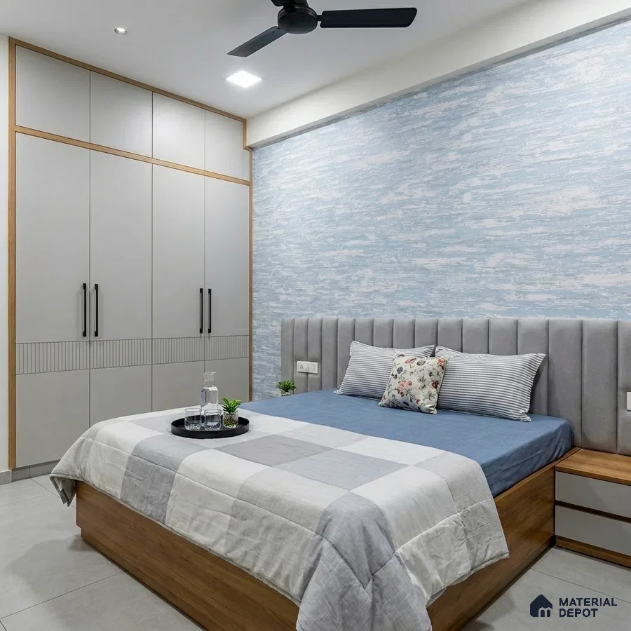 Scandinavian bedroom with light grey wardrobe, blue abstract wallpaper, and suede upholstered headboard