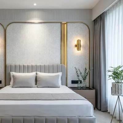 Modern bedroom with suede upholstered bed, gold accent profiles, and textured wallpaper