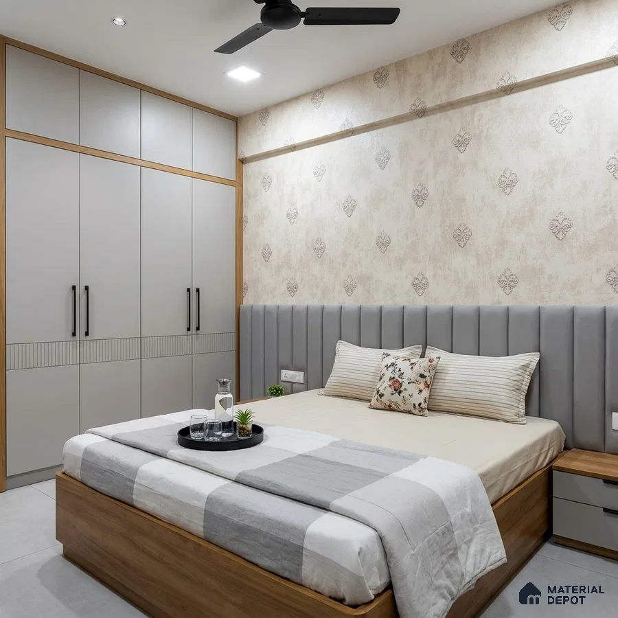 Modern bedroom with grey upholstered headboard, beige patterned wallpaper, and light grey wardrobe laminate