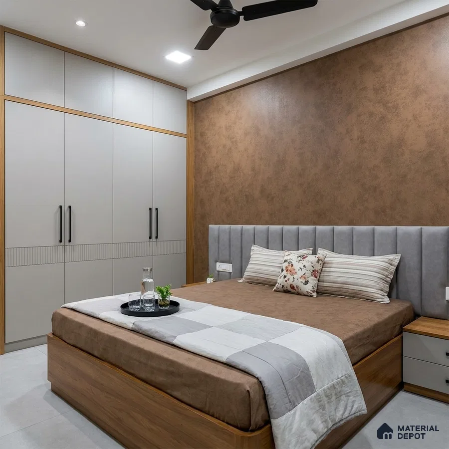 Modern bedroom with matte grey laminate wardrobe, suede upholstered headboard, and brown textured accent wall
