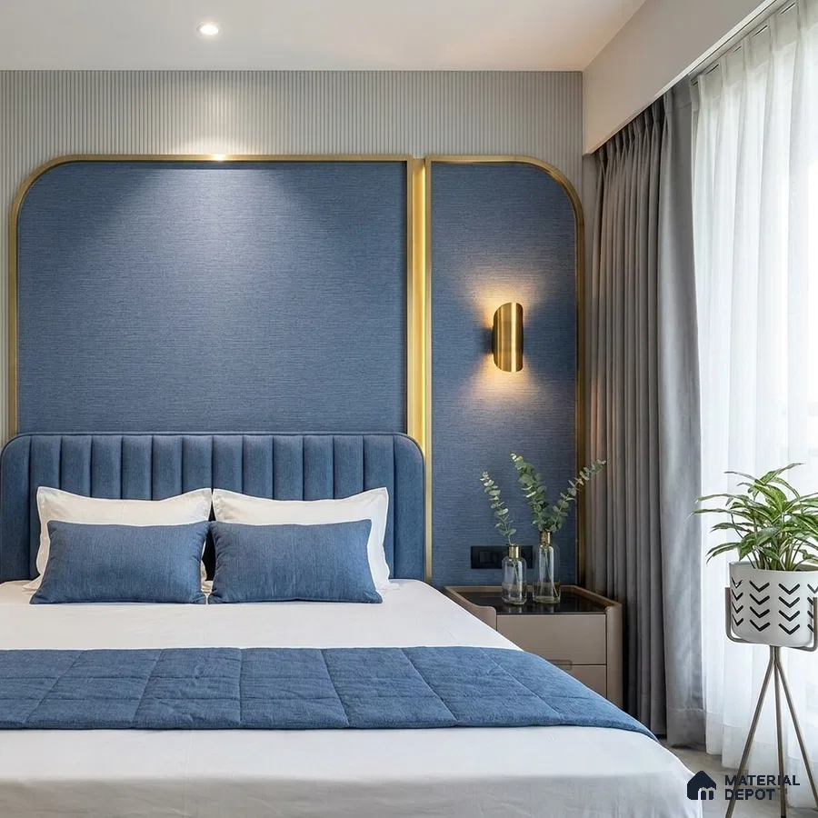 Modern bedroom with blue fabric panel headboard, gold accent trim, and grey drapery