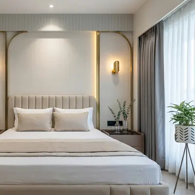 Modern bedroom with beige suede upholstered bed and gold accent wall panels
