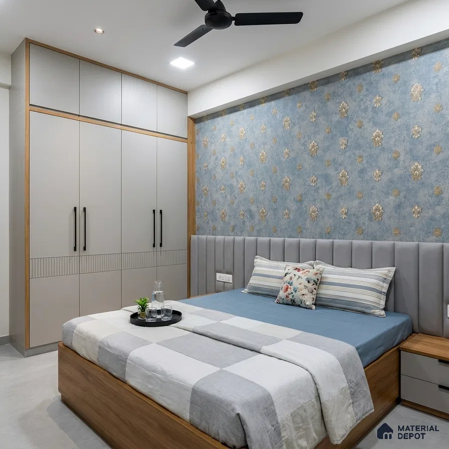 Modern bedroom with blue floral wallpaper, grey suede upholstered headboard, and dual tone wardrobe