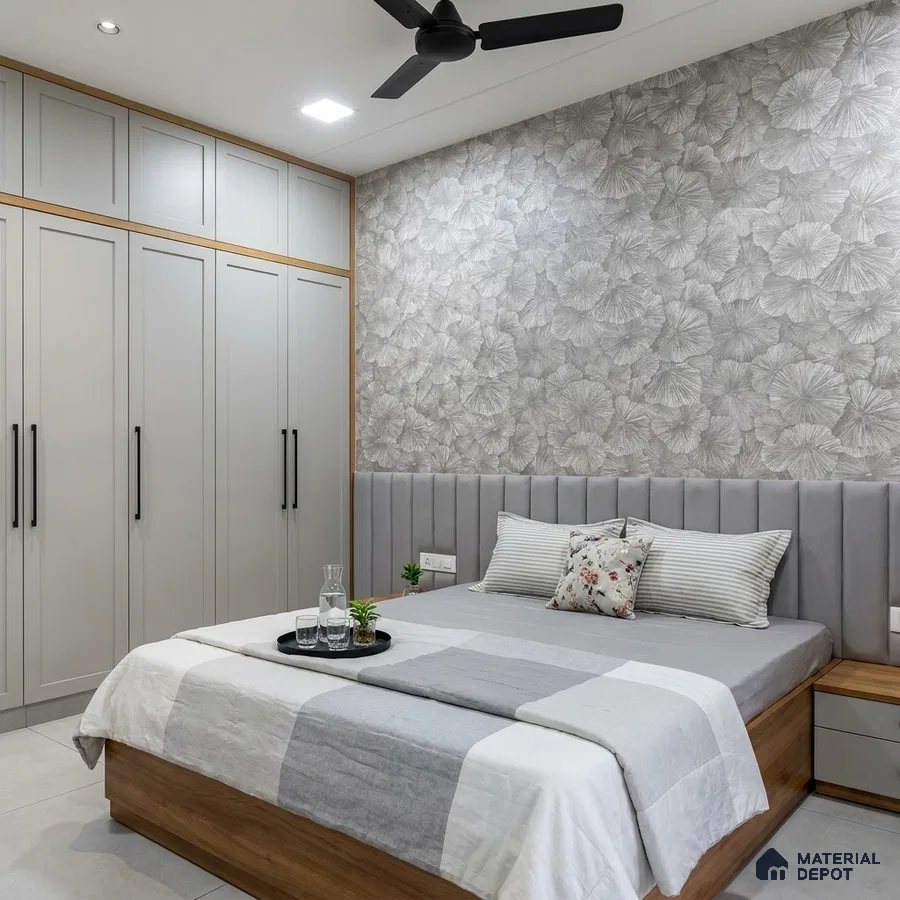 Modern bedroom with grey floral wallpaper, matte grey wardrobe, and suede upholstered headboard