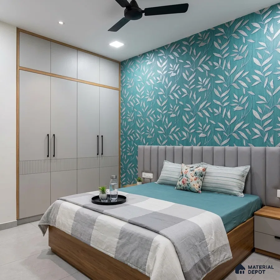 Modern bedroom with teal floral wallpaper, grey upholstered headboard, and dual tone wardrobe