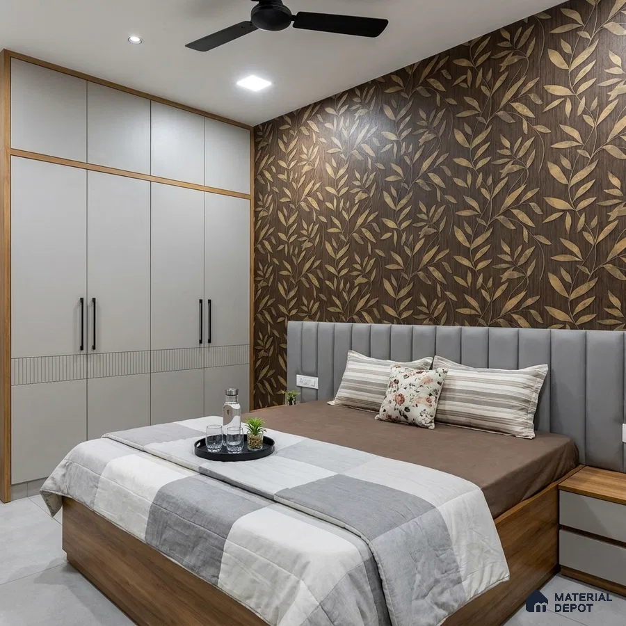 Modern bedroom with leaf-patterned wallpaper, grey solid laminate wardrobe, and wood finish bed