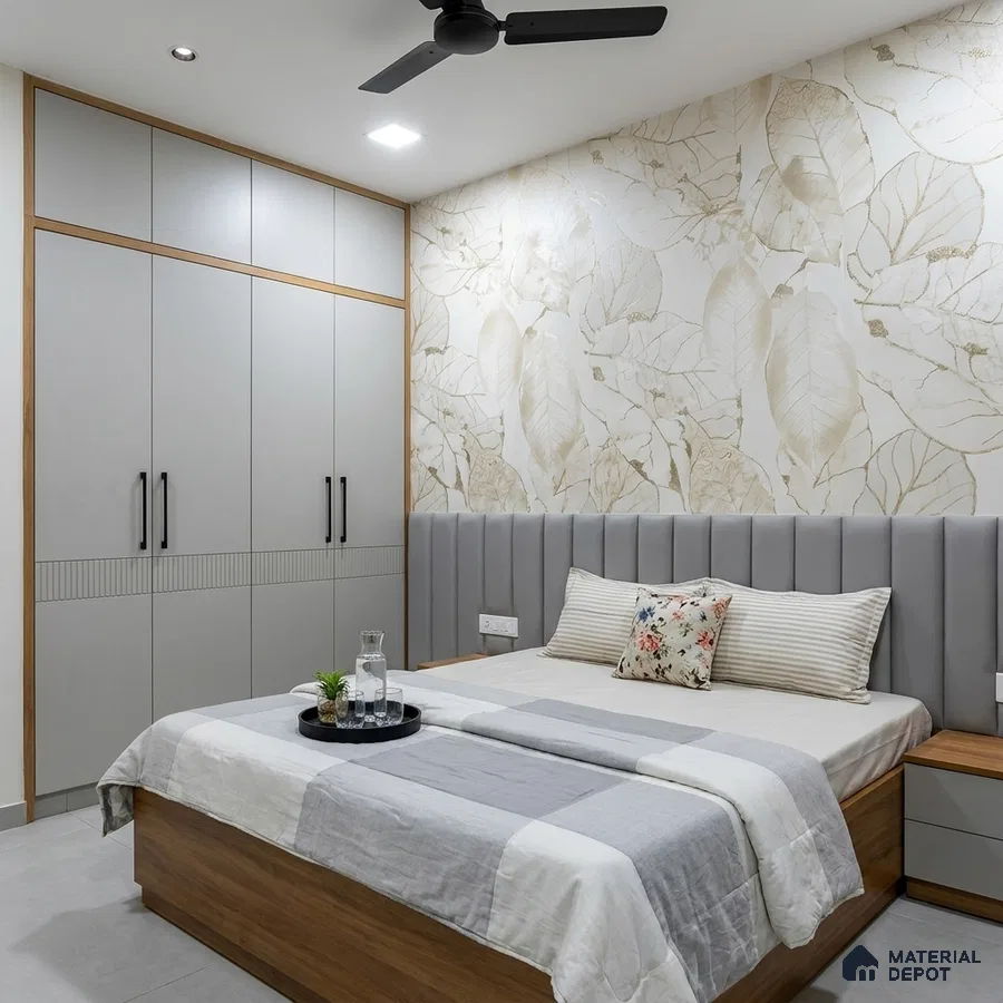 Modern bedroom with beige floral wallpaper, grey upholstered headboard, and light grey wardrobe laminate