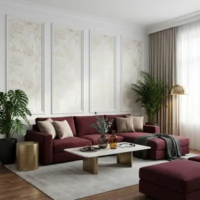 Modern living room with burgundy velvet sofa, gold accent tables, and beige floral wallpaper panels