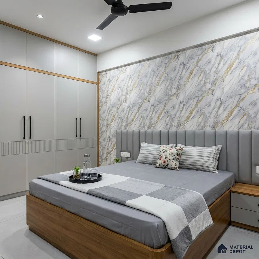 Modern bedroom with marble-look accent wall, grey upholstered headboard, and dual tone wardrobe