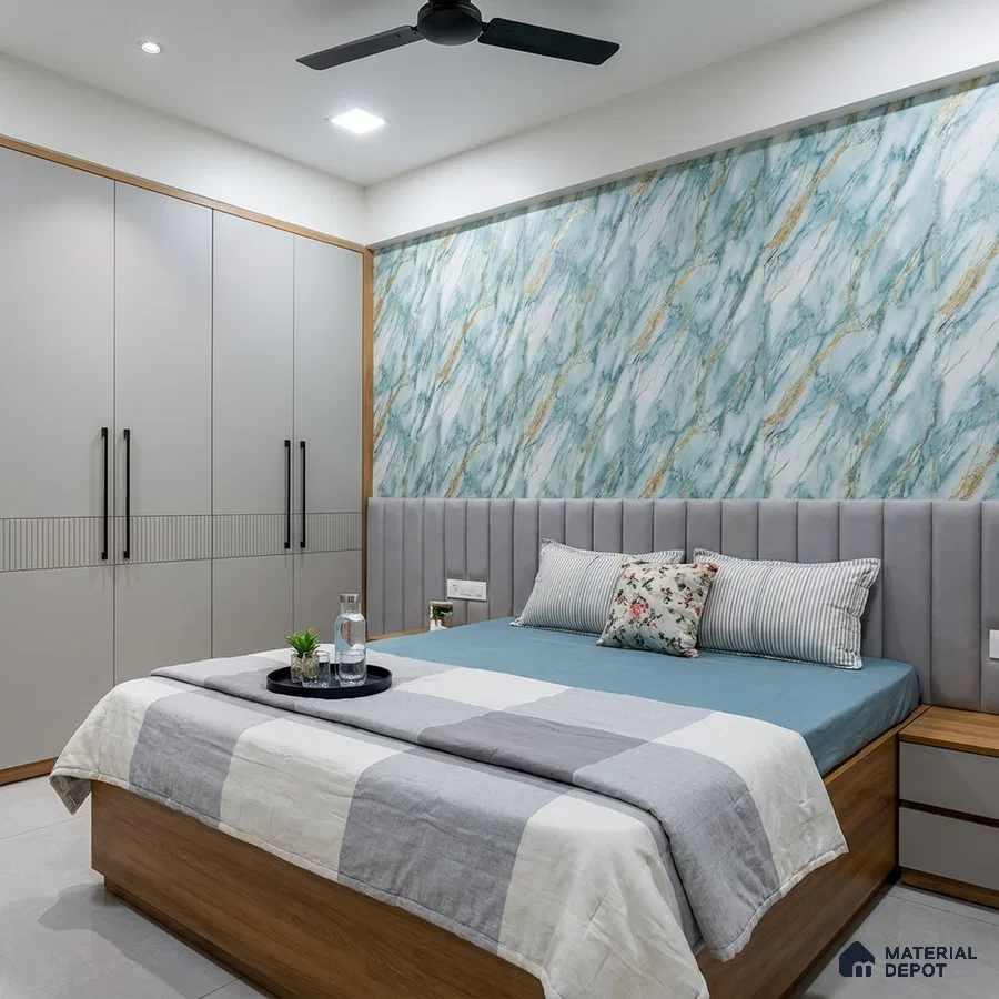 Modern bedroom with blue marble-look wallpaper, grey upholstered headboard, and matte beige wardrobe