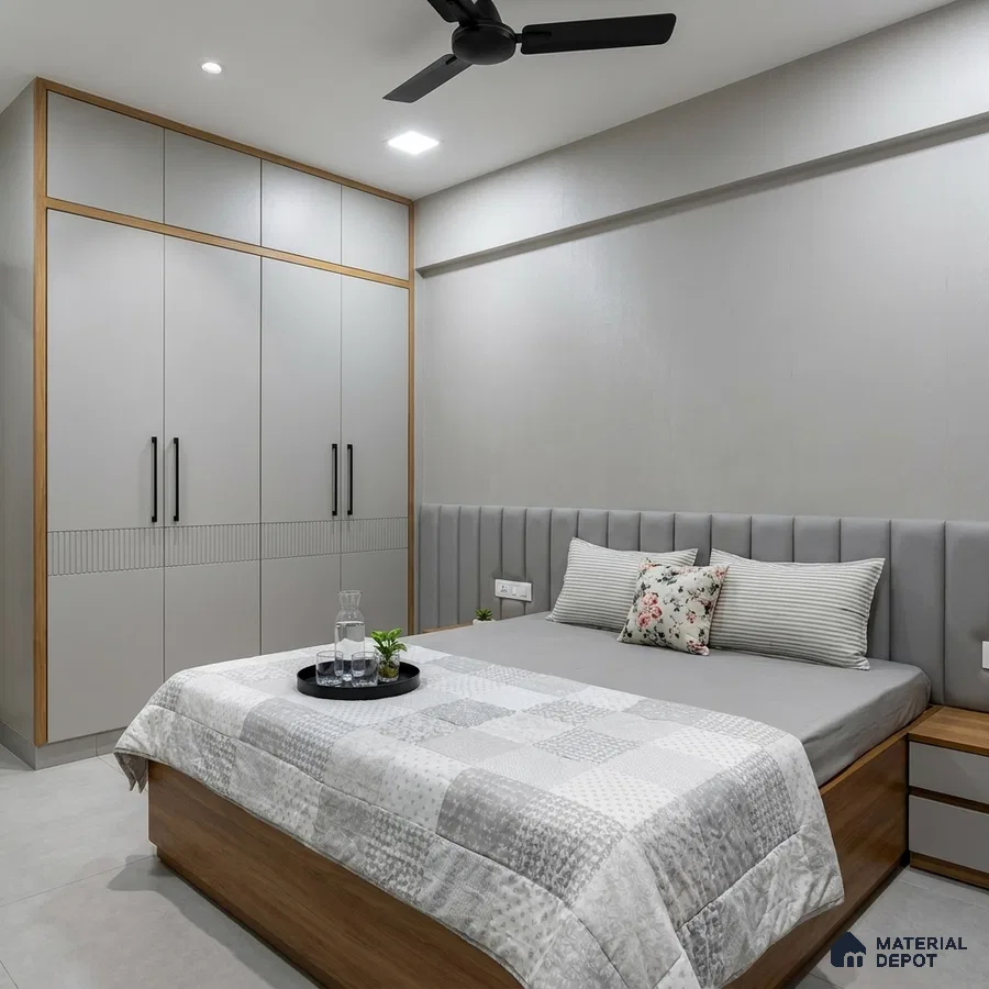 Minimalist bedroom with light grey laminate wardrobe, suede upholstered headboard, and wooden bed frame