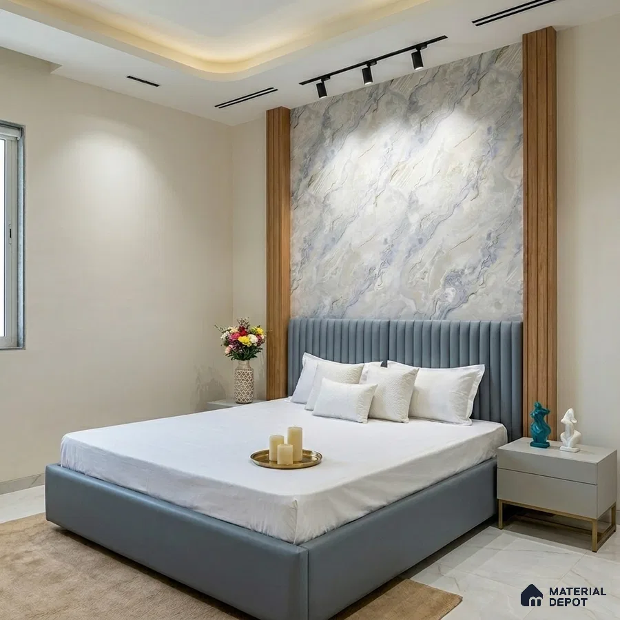 Modern bedroom with marble-look accent wall, fluted wood panels, and suede upholstered bed